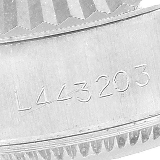 This image shows a close-up of the engraved serial number on the case of a Rolex Datejust 69174 Women's Stainless Steel Beige Dial 69174 Women's Stainless Steel Beige Dial watch.