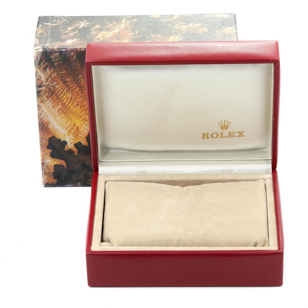 The image shows an open Rolex Datejust 69173 Women
s Stainless Steel Champagne Dial 69173 Women
s Stainless Steel Champagne Dial watch box, revealing the interior with a pillow for the watch.