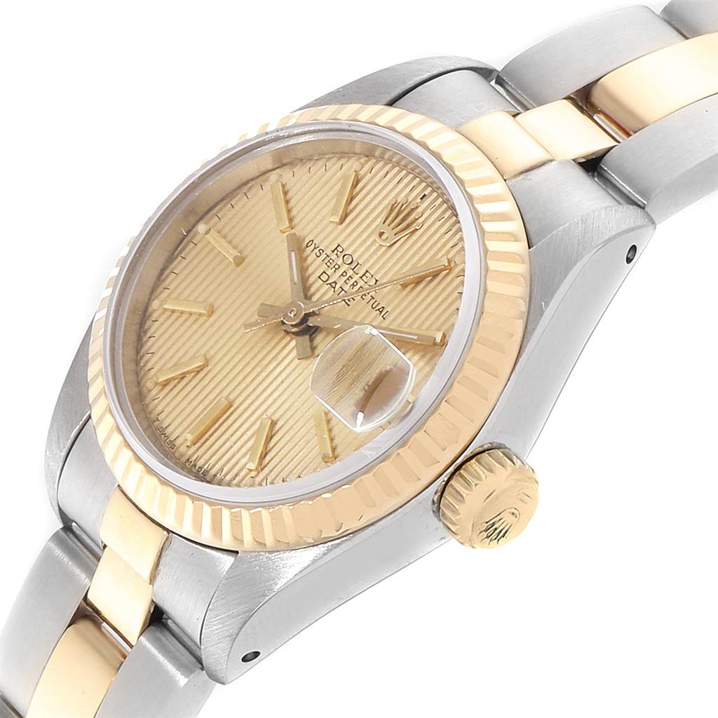 The image shows a Rolex Datejust 69173 Women
s Stainless Steel Champagne Dial 69173 Women
s Stainless Steel Champagne Dial watch from an angled top view, highlighting the bezel, dial, and part of the bracelet.