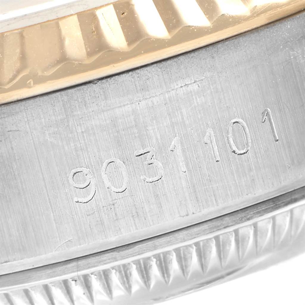 This close-up image shows the side of the Rolex Datejust 69173 Women
s Stainless Steel Champagne Dial 69173 Women
s Stainless Steel Champagne Dial watch, highlighting its serial number and part of the fluted bezel.