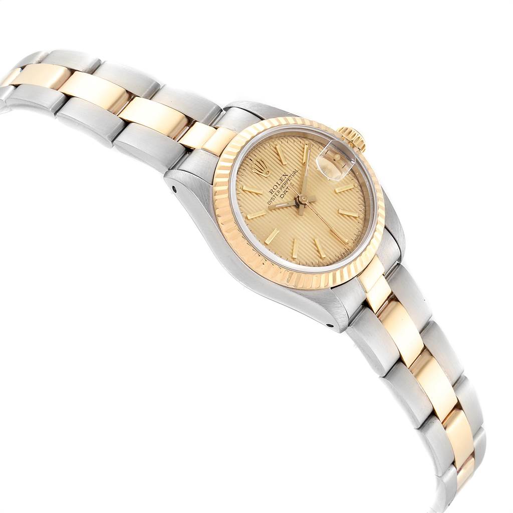 This image shows a Rolex Datejust 69173 Women
s Stainless Steel Champagne Dial 69173 Women
s Stainless Steel Champagne Dial watch from a slight side angle, highlighting its gold and silver bracelet and the face with a date window.