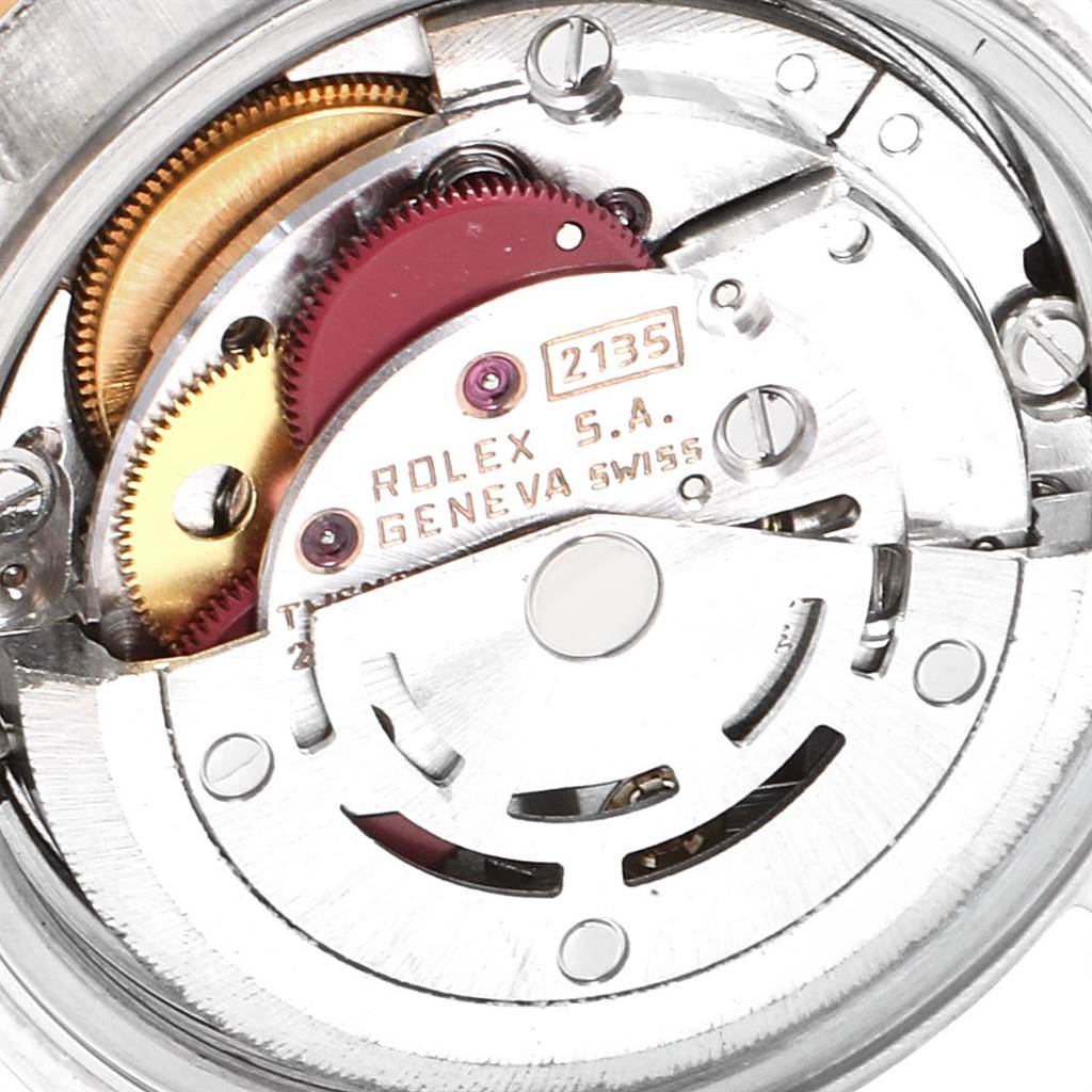This is a close-up shot of the internal mechanism of a Rolex Datejust 69173 Women
s Stainless Steel White Dial 69173 Women
s Stainless Steel White Dial watch, featuring gears and the engraved model number.