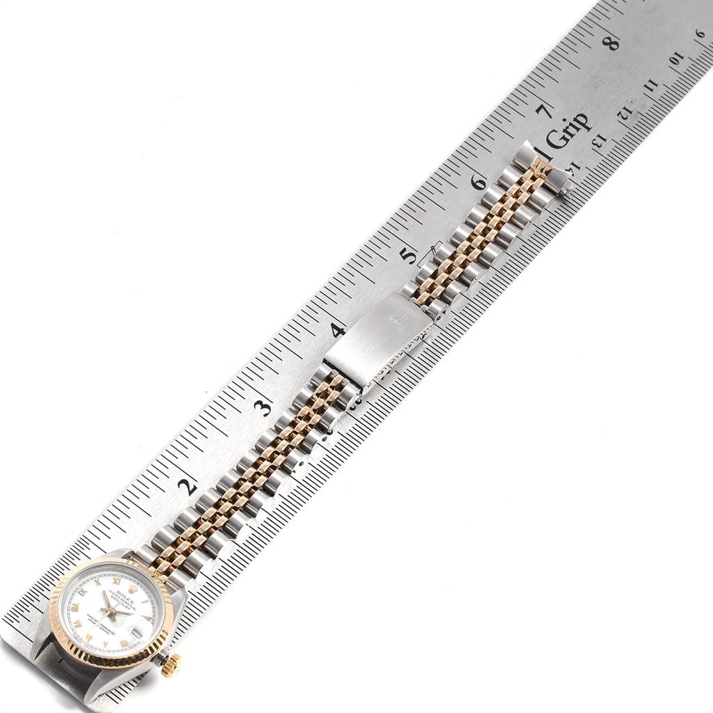 The image shows a Rolex Datejust 69173 Women
s Stainless Steel White Dial 69173 Women
s Stainless Steel White Dial watch laid flat next to a ruler, displaying the watch face and part of the bracelet.