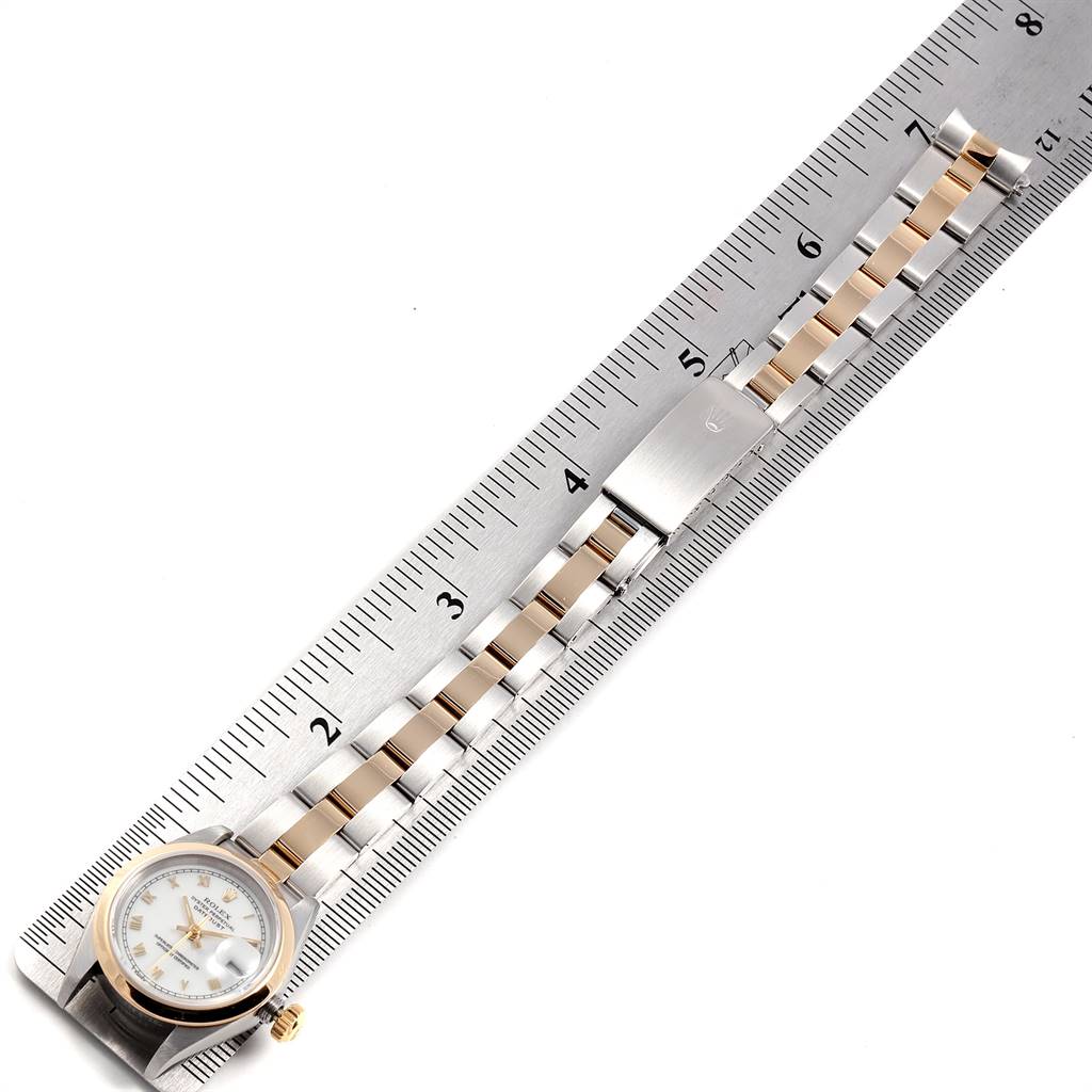 The image shows the Rolex Datejust 69163 Women's Stainless Steel White Dial 69163 Women's Stainless Steel White Dial watch laid flat next to a ruler, displaying the face, band, and clasp.