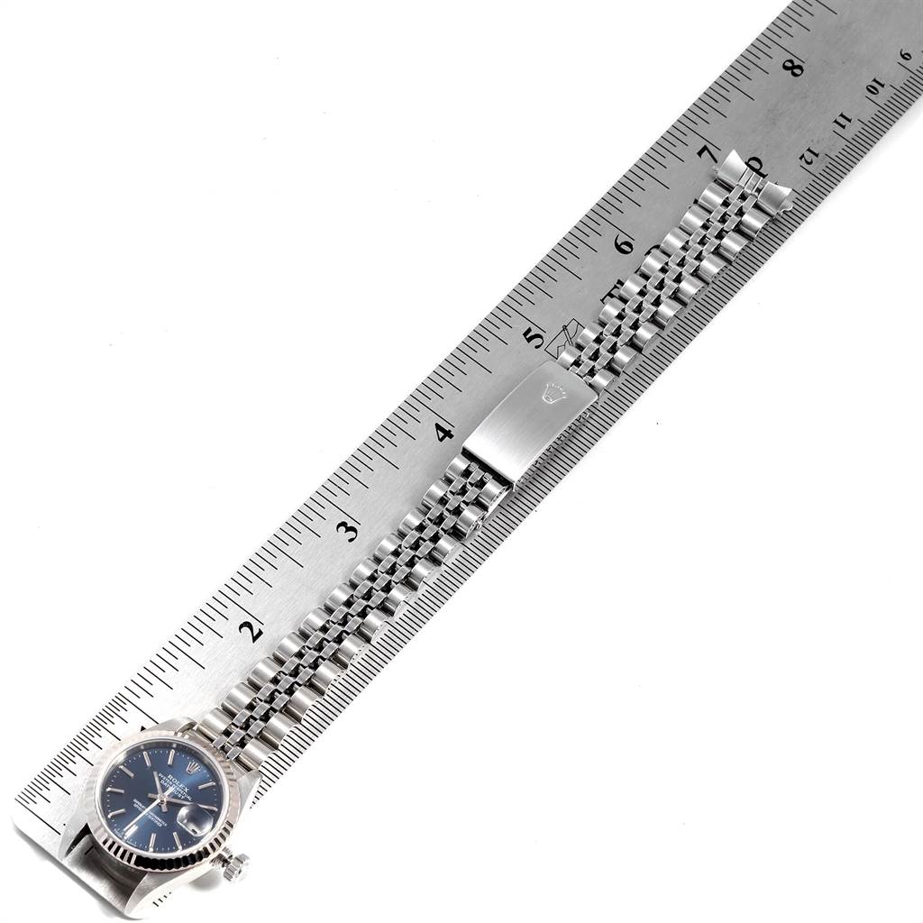 The image shows a Rolex Datejust 79174 Women's Stainless Steel Blue Dial 79174 Women's Stainless Steel Blue Dial watch with its bracelet stretched out along a ruler, viewed from above.