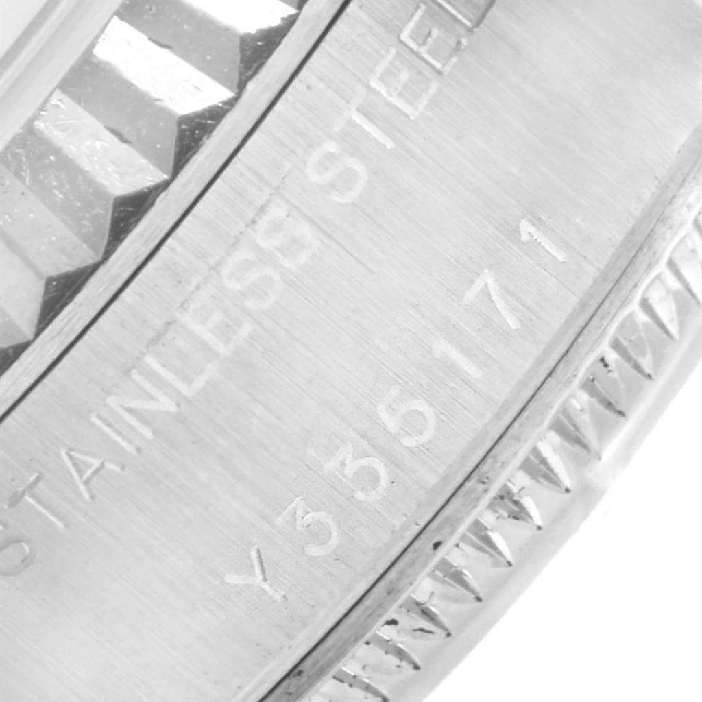 This image shows a close-up of the Rolex Datejust 79174 Women's Stainless Steel White Dial 79174 Women's Stainless Steel White Dial model's stainless steel case with engraved serial numbers.