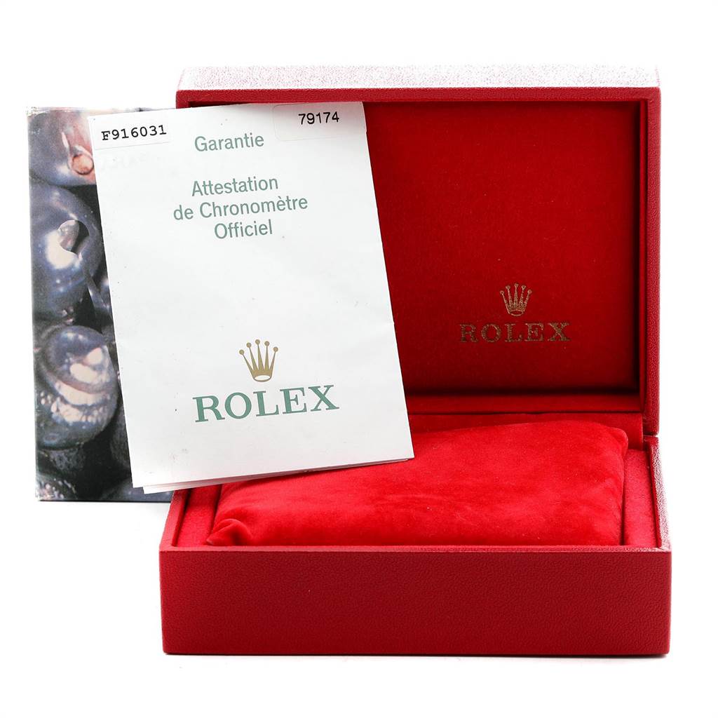 The image shows a red Rolex Datejust 79174 Women
s Stainless Steel Silver Dial 79174 Women
s Stainless Steel Silver Dial watch box, an official chronometer certification, and a red cushion inside the box.