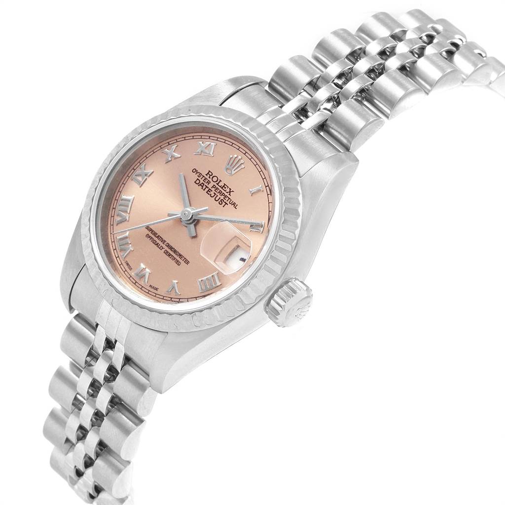 The image shows a close-up of a Rolex Datejust 79174 Women's Stainless Steel Pink Dial 79174 Women's Stainless Steel Pink Dial watch, highlighting its face, bezel, crown, and part of the bracelet at an angle.