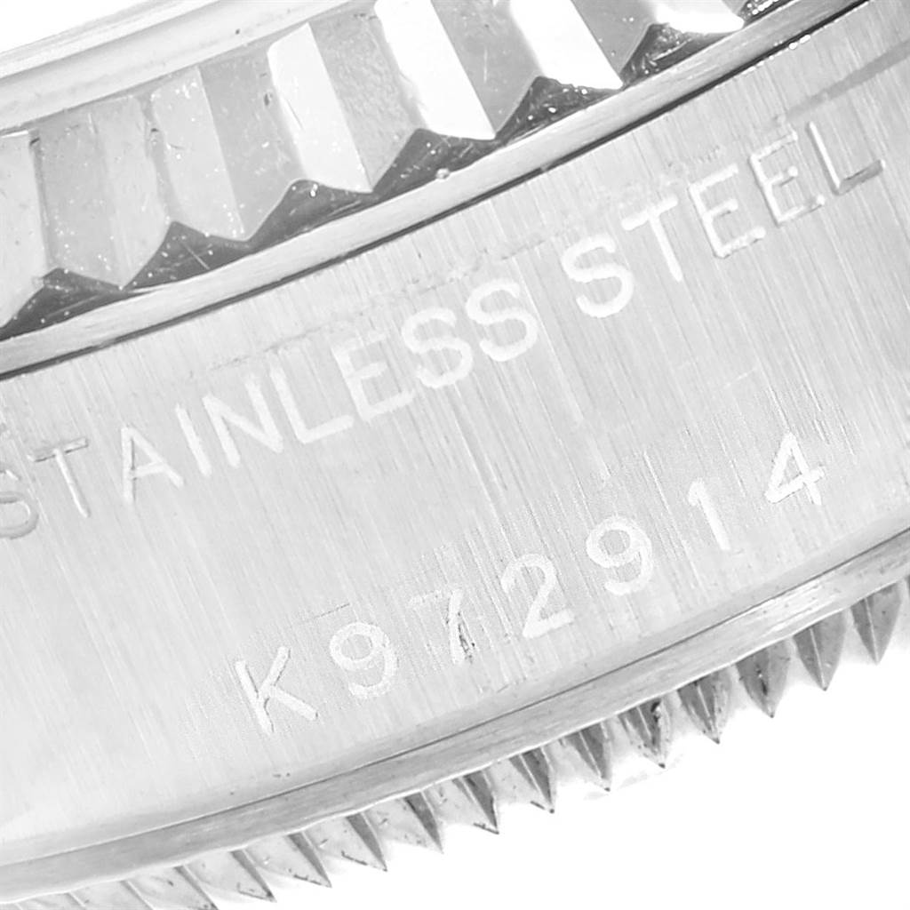 This image shows a close-up of the serial number and fluted bezel on a stainless steel Rolex Datejust 79174 Women's Stainless Steel Pink Dial 79174 Women's Stainless Steel Pink Dial watch.