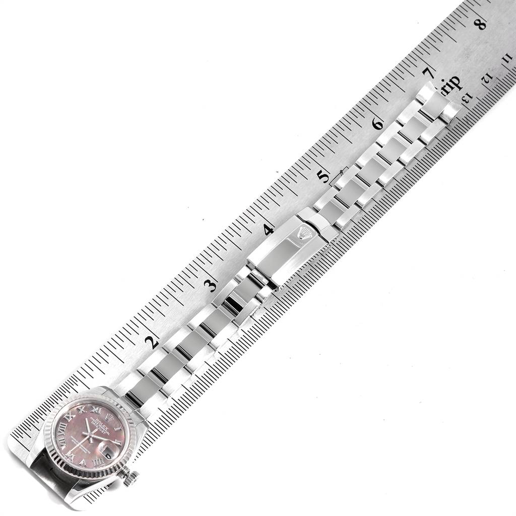 The image shows the face and metal bracelet of a Rolex Datejust 179174 Women's Stainless Steel Mother of Pearl Dial 179174 Women's Stainless Steel Mother of Pearl Dial watch next to a measuring ruler.