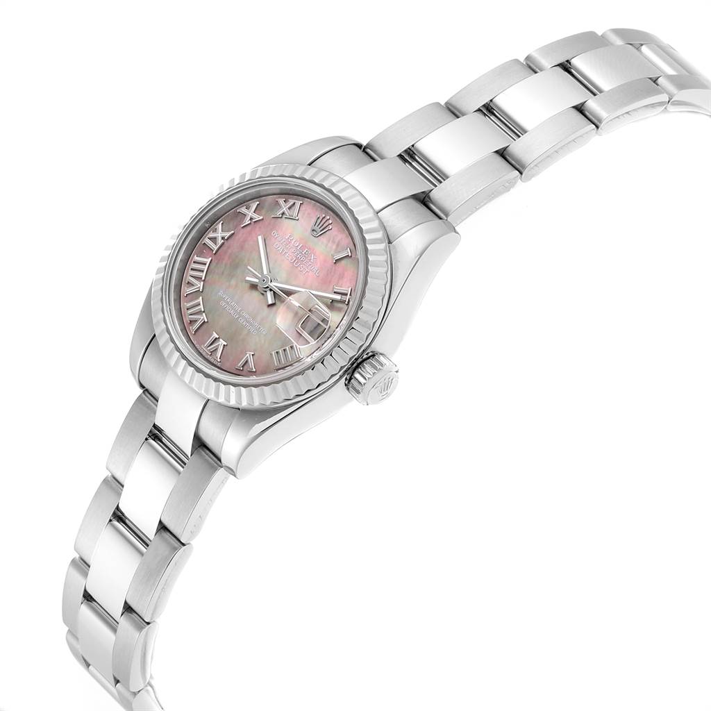 This Rolex Datejust 179174 Women's Stainless Steel Mother of Pearl Dial 179174 Women's Stainless Steel Mother of Pearl Dial watch is shown at a three-quarter angle, highlighting its pink face with Roman numerals, fluted bezel, and metal bracelet.