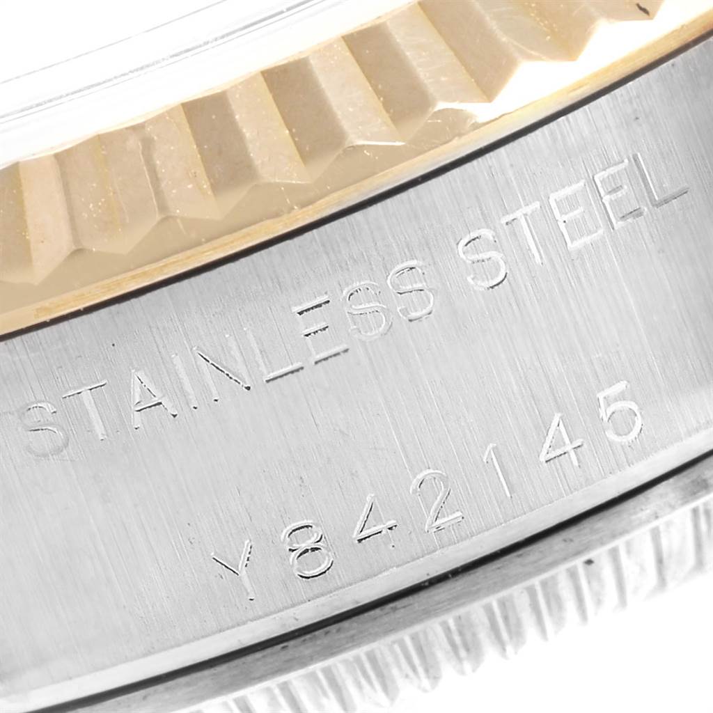 The image shows a close-up of the side view of the stainless steel casing of a Rolex Datejust 79173 Women
s Stainless Steel Black Dial 79173 Women
s Stainless Steel Black Dial watch, including part of the fluted bezel.