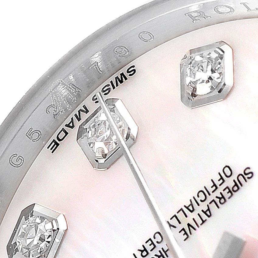 Close-up of a Rolex Datejust 179174 Women
s Stainless Steel Mother of Pearl Dial 179174 Women
s Stainless Steel Mother of Pearl Dial watch face, showing part of the dial with diamond hour markers and the "Swiss Made" engraving.