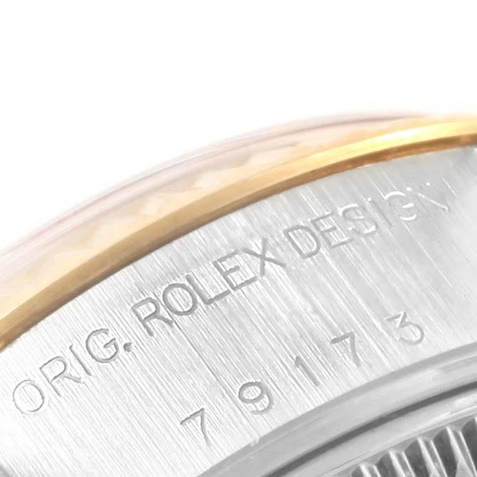 The image shows a close-up of the side of a Rolex Datejust 79173 Women's Stainless Steel Champagne Dial 79173 Women's Stainless Steel Champagne Dial watch case, highlighting the engraved model number and brand.
