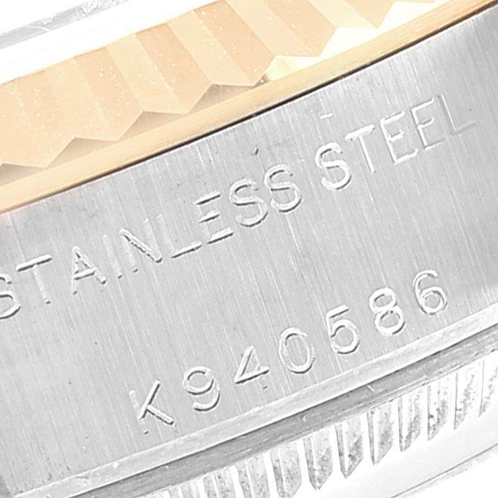 This close-up image shows the engraved side of the case and fluted bezel of a Rolex Datejust 79173 Women's Stainless Steel Champagne Dial 79173 Women's Stainless Steel Champagne Dial.