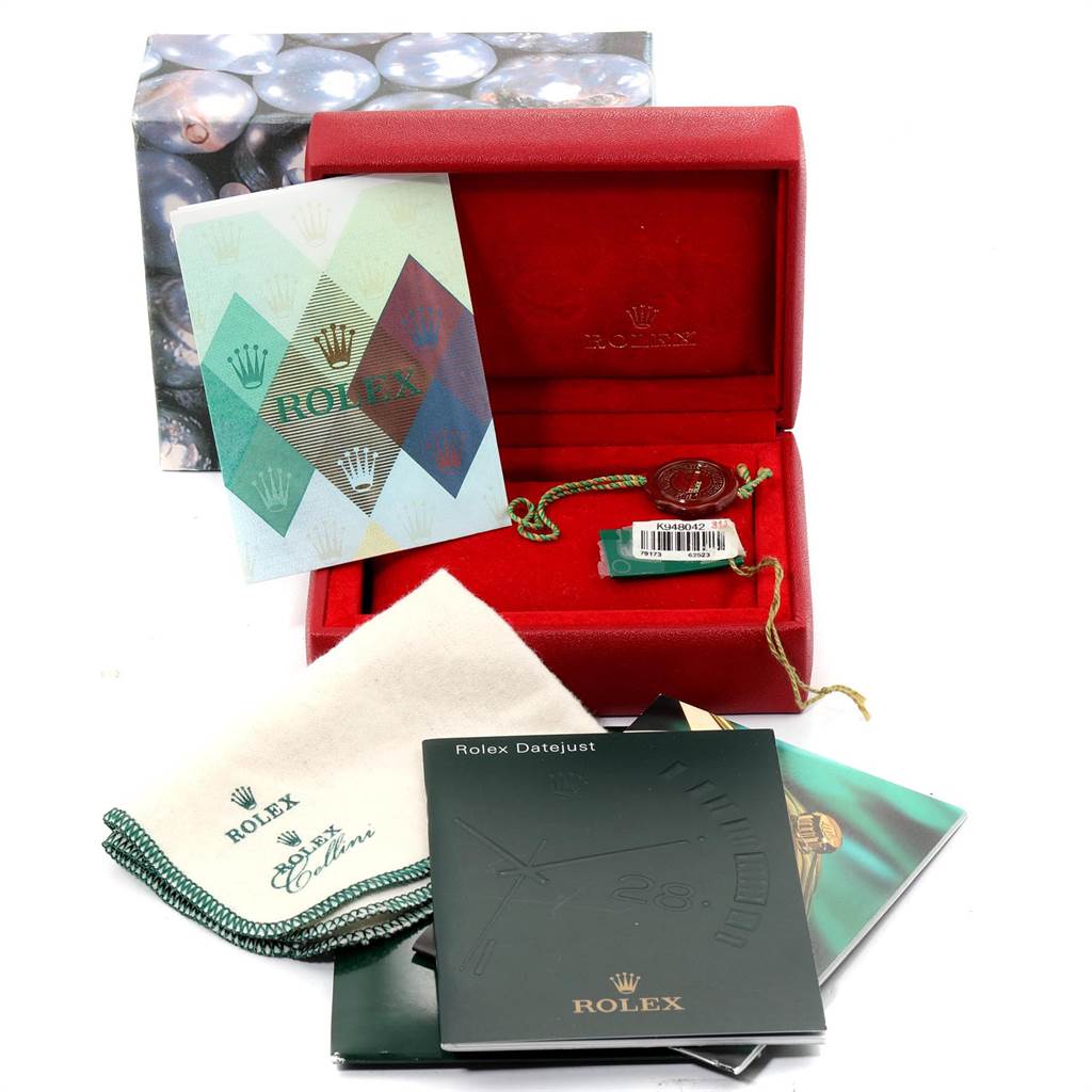 The image shows a Rolex Datejust 79173 Women's Steel and Gold (two tone) Black Dial 79173 Women's Steel and Gold (two tone) Black Dial watch box, booklets, a tag, and a cleaning cloth.