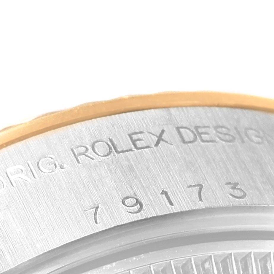 Close-up angle shows part of the watch case with "ORIG. ROLEX DESIGN" and numbers on the Rolex Datejust 79173 Women's Steel and Gold (two tone) Black Dial 79173 Women's Steel and Gold (two tone) Black Dial model.