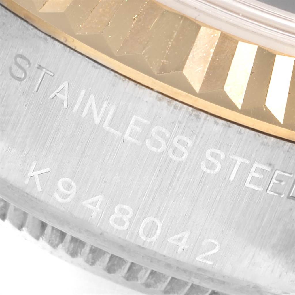 The image shows a close-up of the bezel and case serial number of a Rolex Datejust 79173 Women's Steel and Gold (two tone) Black Dial 79173 Women's Steel and Gold (two tone) Black Dial.