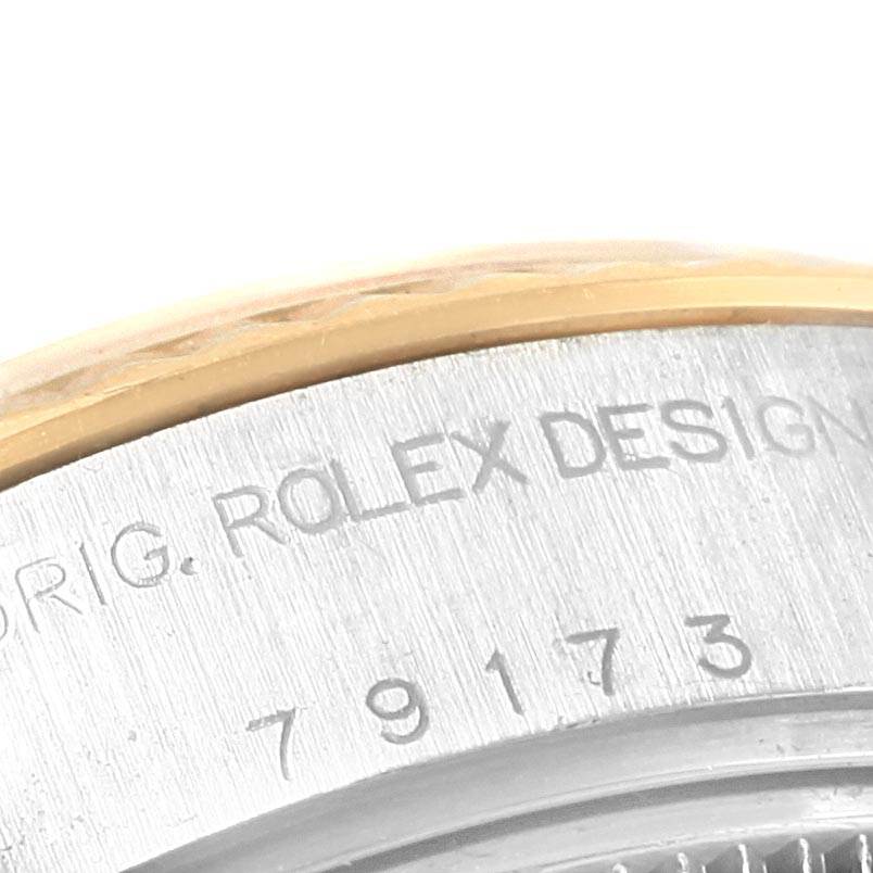 The image shows a close-up angle of the case back of a Rolex Datejust 79173 Women's Steel and Gold (two tone) Grey Dial 79173 Women's Steel and Gold (two tone) Grey Dial watch, highlighting the "ROLEX DESIGN" engraving and part of the serial number.