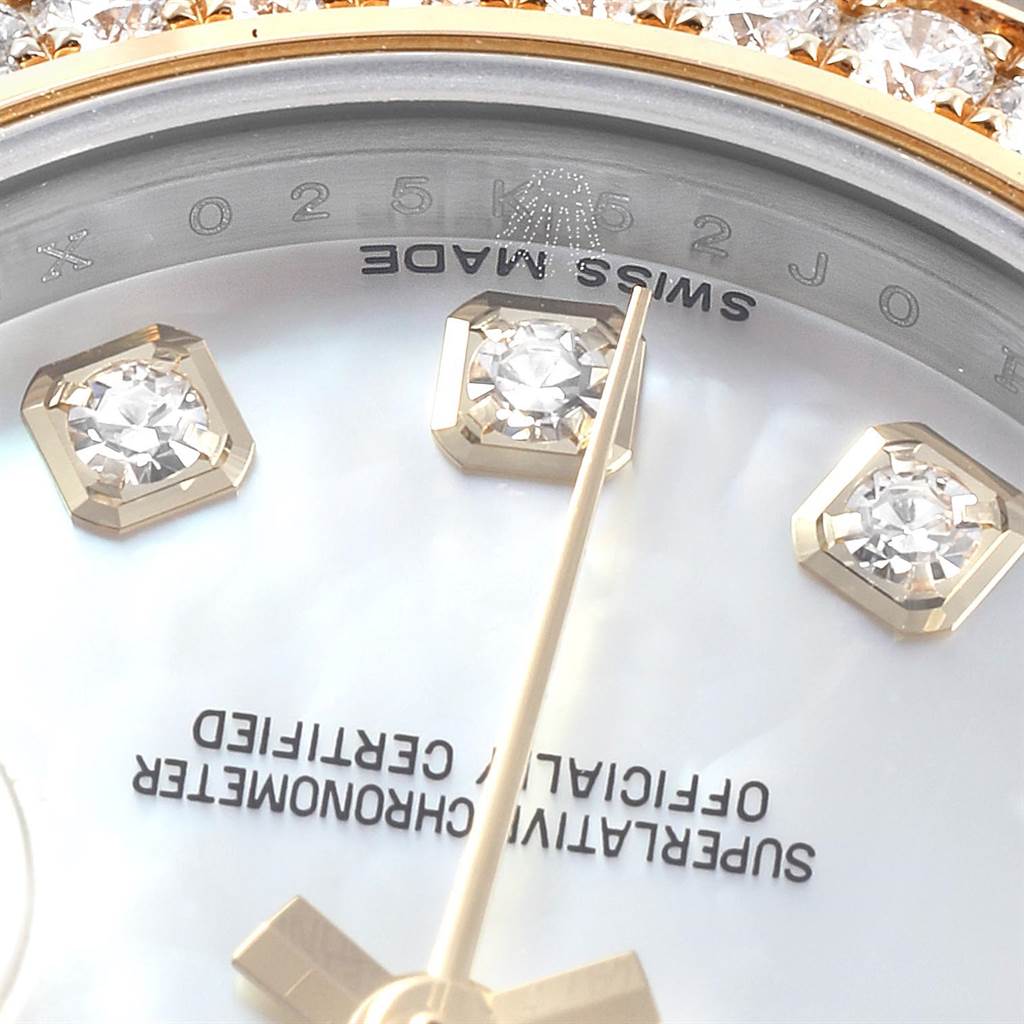 Close-up of the Rolex Datejust 179383 Women's Steel and Gold (two tone) Mother of Pearl Dial 179383 Women's Steel and Gold (two tone) Mother of Pearl Dial watch's dial with diamond hour markers and part of the bezel.