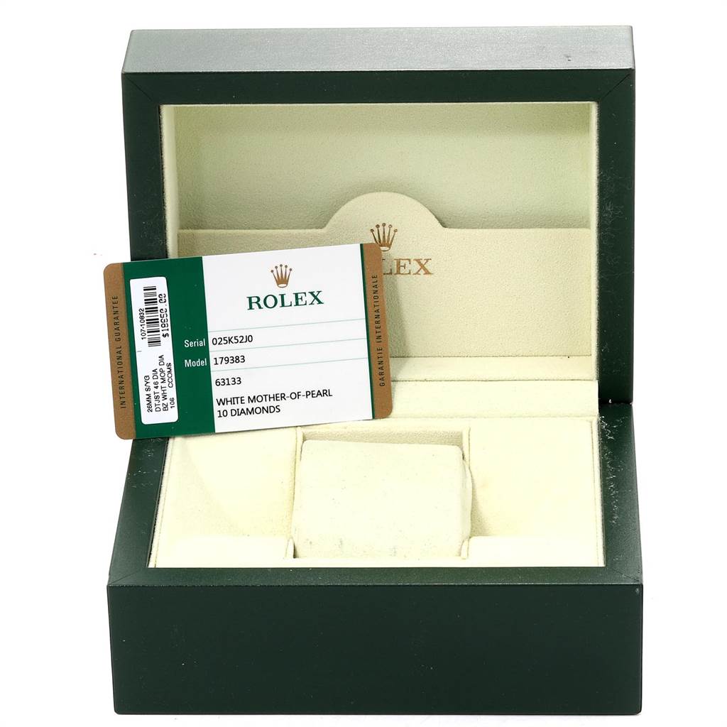 The image shows an open green Rolex box for a Datejust model with its warranty card displayed inside.