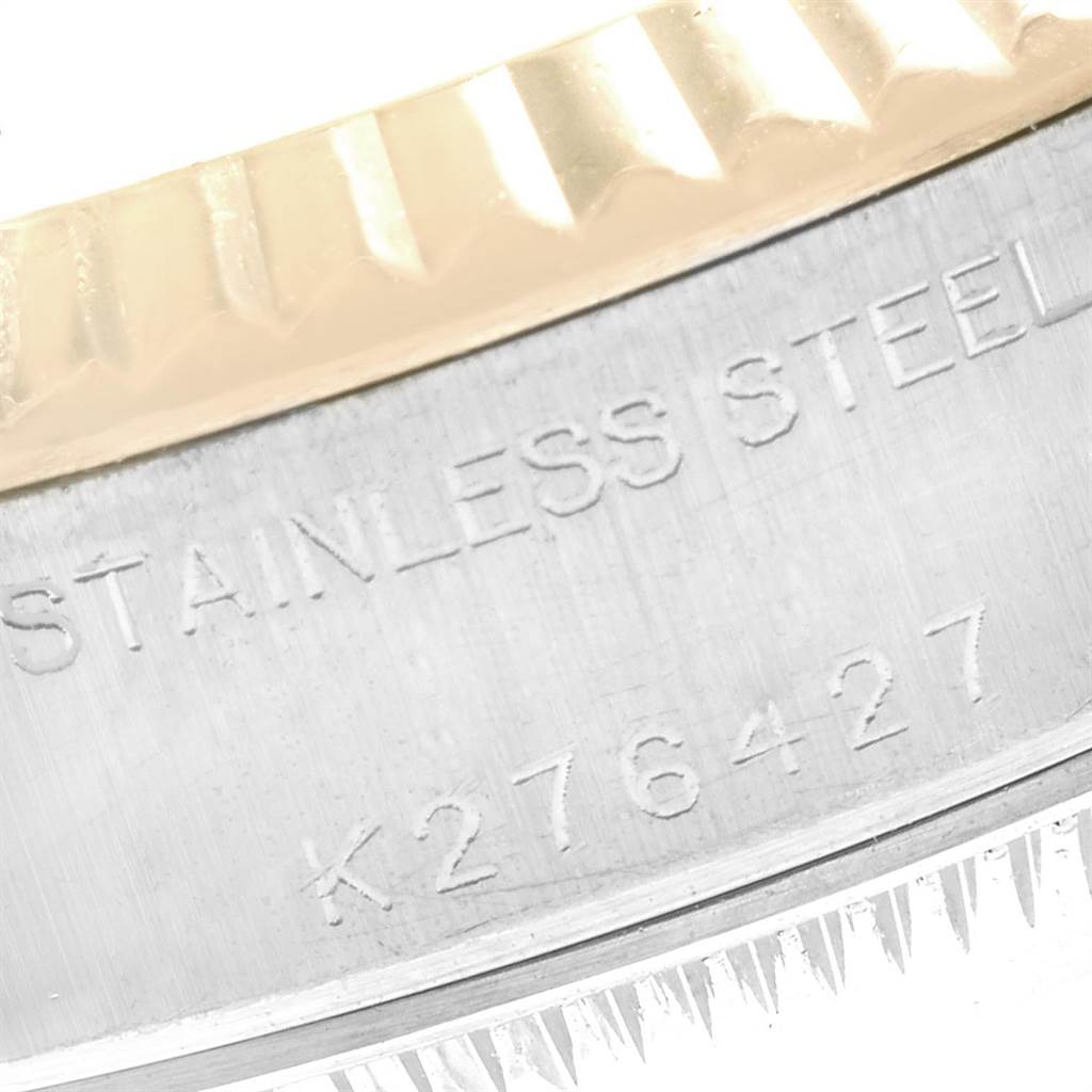 The image shows an angled close-up of the stainless steel side and fluted bezel of a Rolex Datejust 79173 Women's Steel and Gold (two tone) Silver Dial 79173 Women's Steel and Gold (two tone) Silver Dial watch, displaying the serial number.