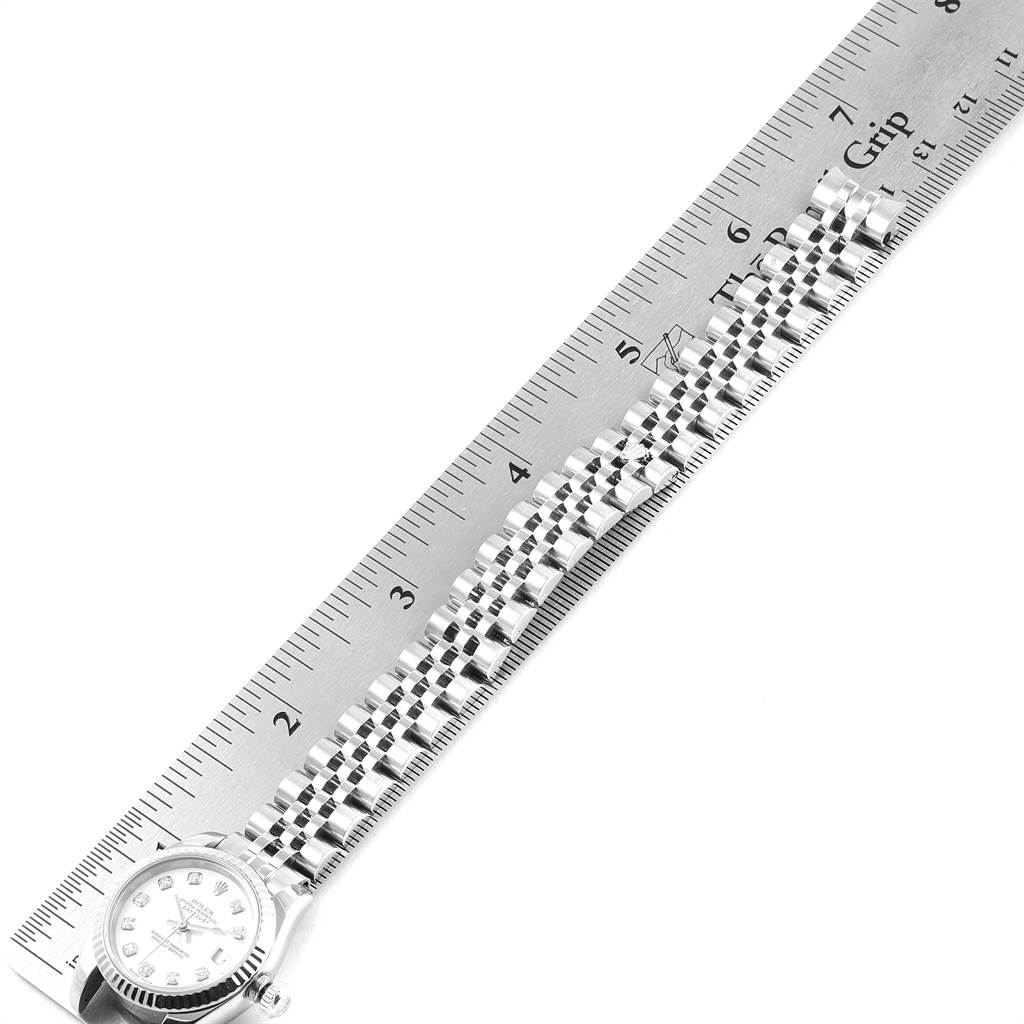 The image shows the bracelet and part of the case of a Rolex Datejust 179174 Women
s Stainless Steel White Dial 179174 Women
s Stainless Steel White Dial watch, aligned next to a ruler.