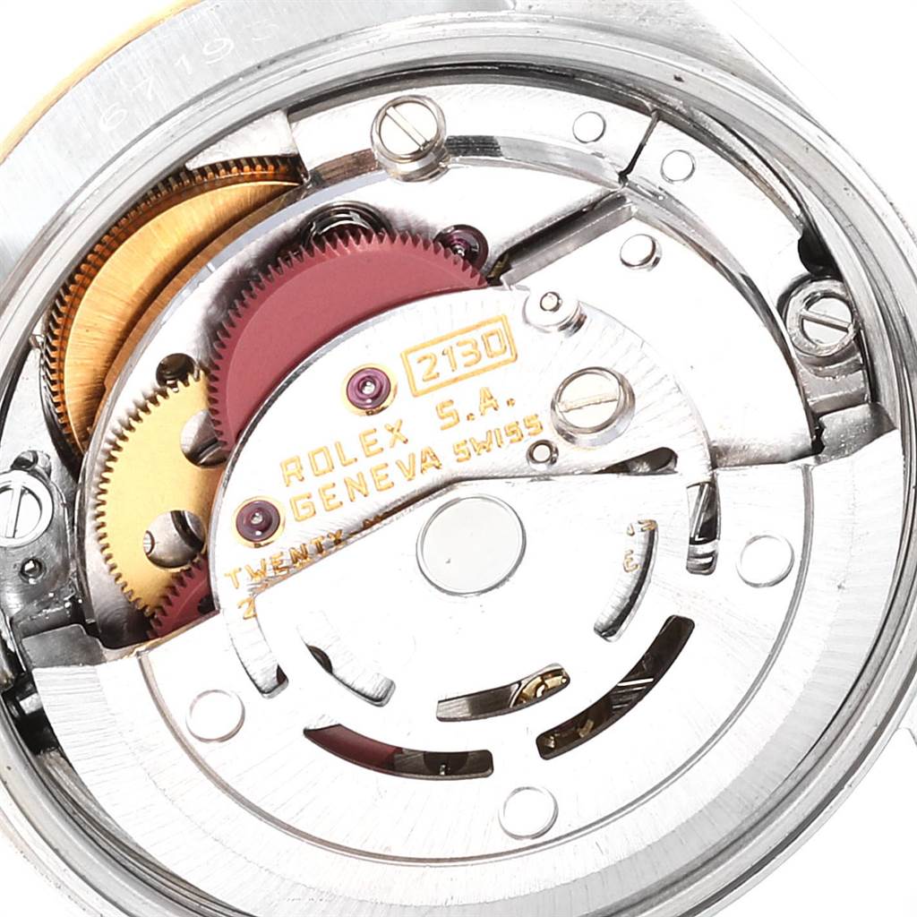 The image shows the internal mechanical movement parts of a Rolex Datejust 67193 Women's Steel and Gold (two tone) Champagne Dial 67193 Women's Steel and Gold (two tone) Champagne Dial watch, including gears and the rotor.