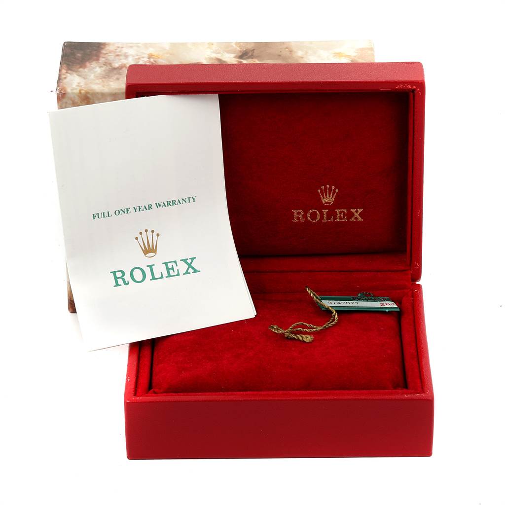 The image shows an open red Rolex box with a warranty card, likely related to the Datejust model.