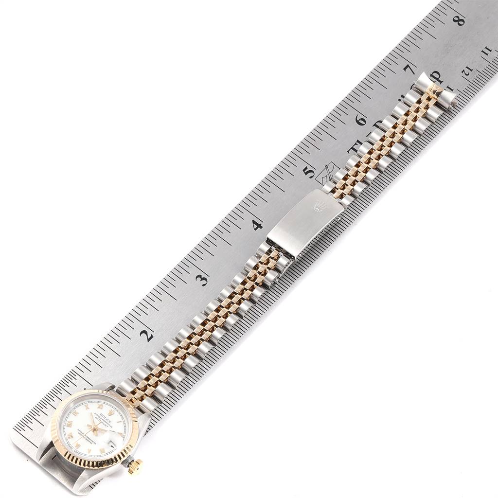 The image shows a Rolex Datejust 69173 Women's Stainless Steel White Dial 69173 Women's Stainless Steel White Dial watch laid flat along a ruler, showcasing its bracelet and dial partially.