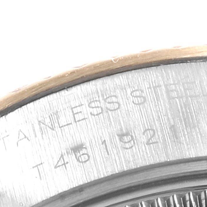 The image shows a close-up of the stainless steel case back and edge of the bezel of a Rolex Datejust 69173 Women's Stainless Steel White Dial 69173 Women's Stainless Steel White Dial watch.