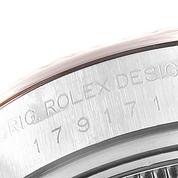 The image shows a close-up of the engraved edge of a Rolex Datejust 179171 Women's Steel and Gold (two tone) Silver Dial 179171 Women's Steel and Gold (two tone) Silver Dial watch case.