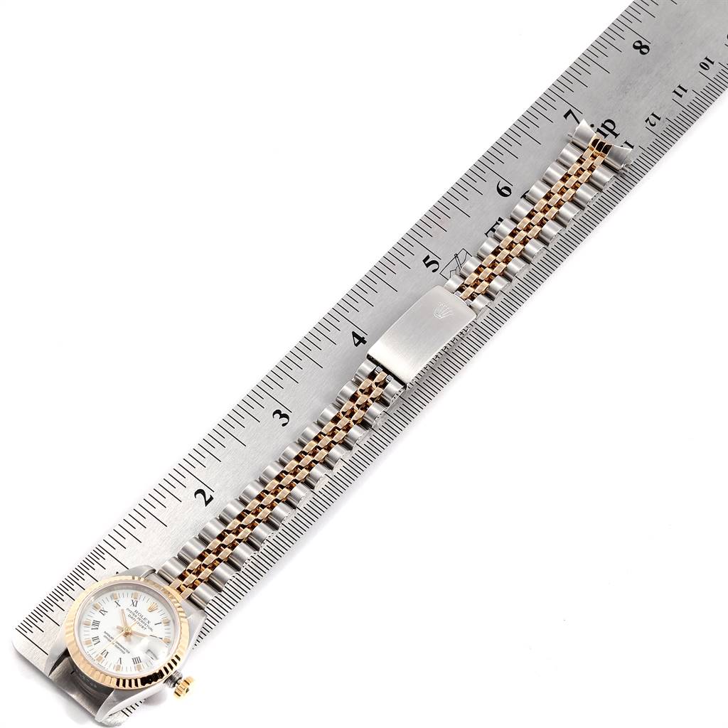 The Rolex Datejust 69173 Women's Stainless Steel White Dial 69173 Women's Stainless Steel White Dial watch is shown with its band extended and measured against a ruler.