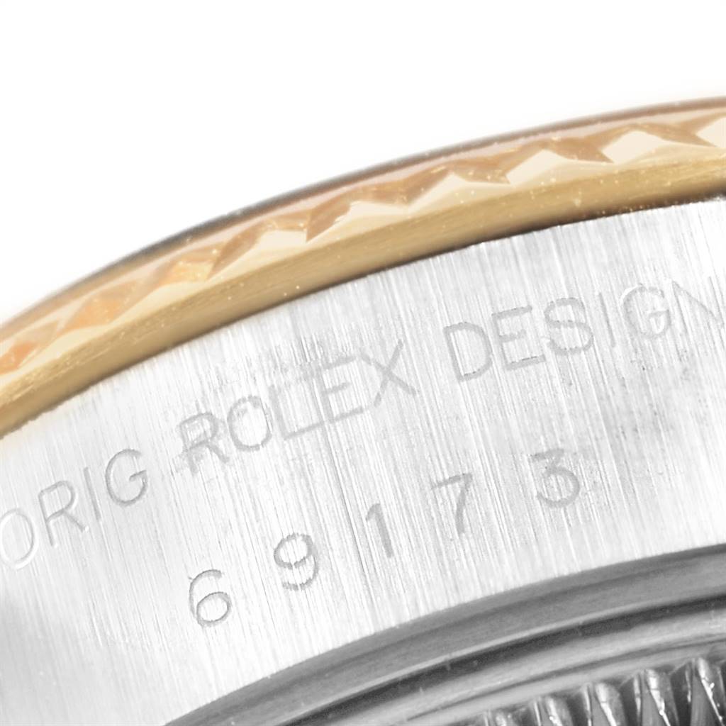 Close-up of the Rolex Datejust 69173 Women's Stainless Steel Champagne Dial 69173 Women's Stainless Steel Champagne Dial model's bezel and engravings on the side of the watch case.