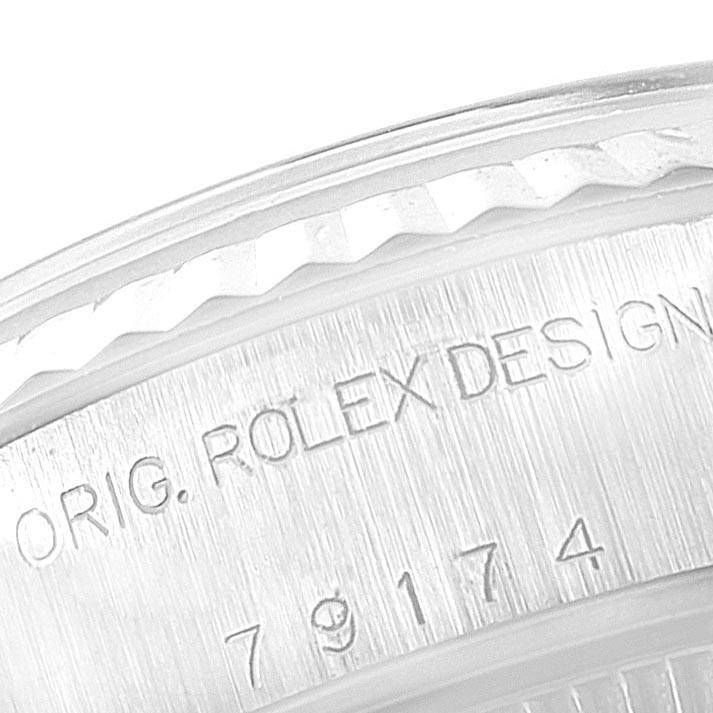 Close-up of the bezel and case side of the Rolex Datejust 79174 Women's Stainless Steel Mother of Pearl Dial 79174 Women's Stainless Steel Mother of Pearl Dial, showing part of the watch's serial number and "ROLEX DESIGN" engraving.
