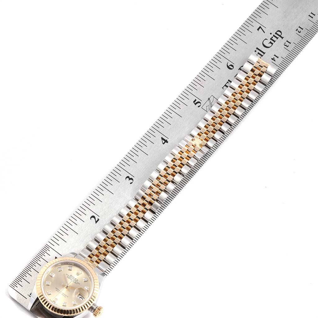 This image shows a Rolex Datejust 279173 Women's Steel and Gold (two tone) Champagne Dial 279173 Women's Steel and Gold (two tone) Champagne Dial watch with a two-tone bracelet next to a ruler for measurement.