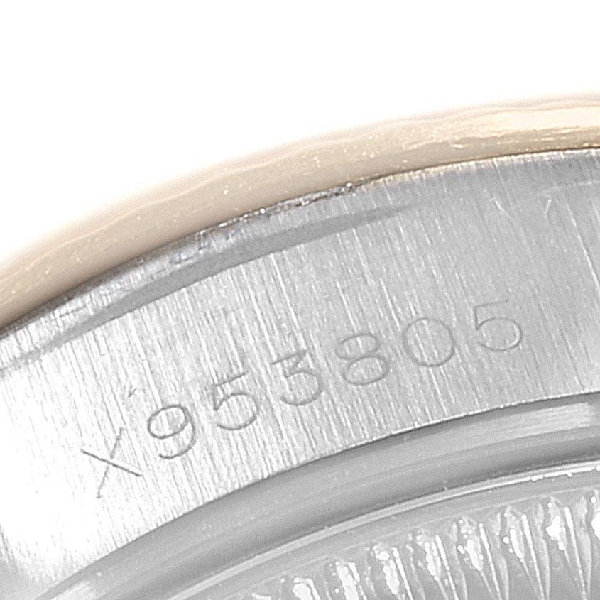 This close-up image shows the engraved serial number on the side of the case of a Rolex Datejust 69173 Women's Stainless Steel Champagne Dial 69173 Women's Stainless Steel Champagne Dial watch.