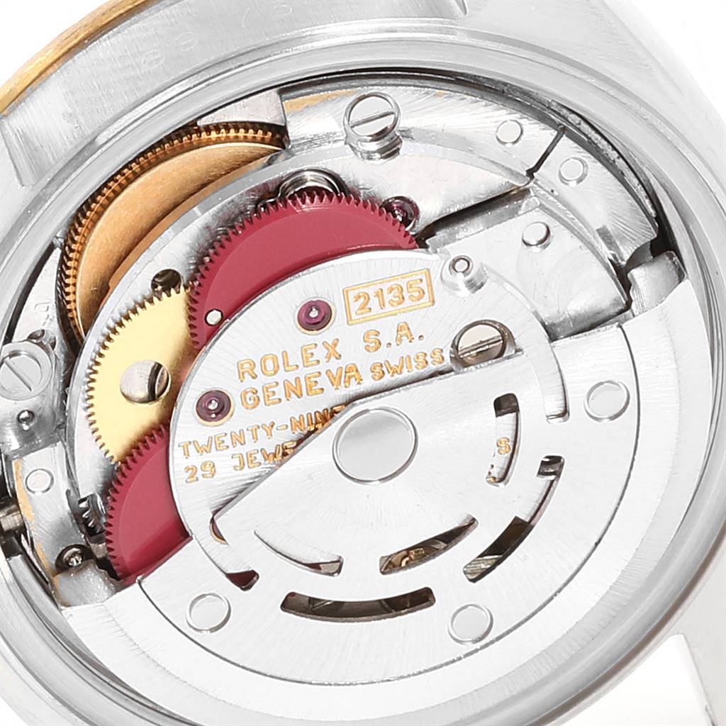 The image shows a close-up view of the internal mechanism of a Rolex Datejust 69173 Women's Stainless Steel Champagne Dial 69173 Women's Stainless Steel Champagne Dial watch, including gears and the rotor.