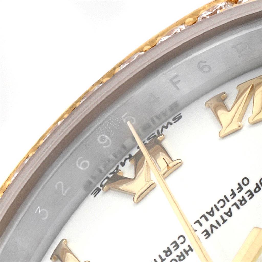 This close-up image of the Rolex Datejust 279383 Women's Steel and Gold (two tone) White Dial 279383 Women's Steel and Gold (two tone) White Dial watch shows part of the dial, bezel, and the "Swiss Made" inscription.