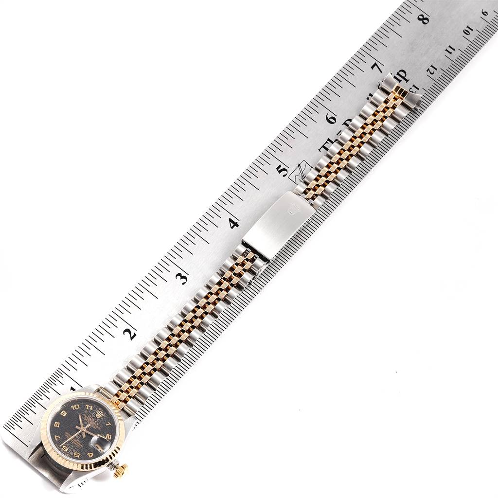 The image shows a Rolex Datejust 69173 Women's Stainless Steel Black Dial 69173 Women's Stainless Steel Black Dial watch lying flat next to a ruler, highlighting its bracelet and clasp.