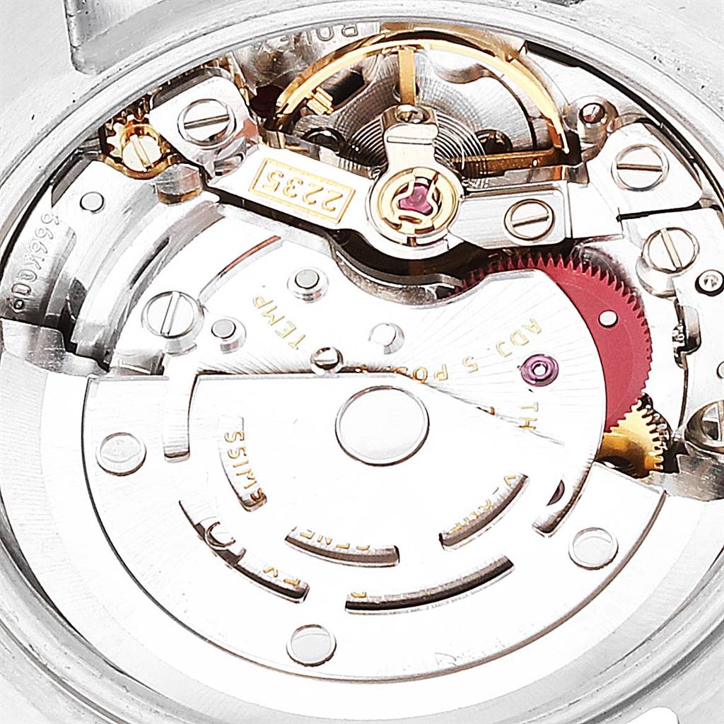The image shows the intricate internal mechanism of a Rolex Datejust 179174 Women's Stainless Steel Silver Dial 179174 Women's Stainless Steel Silver Dial watch, highlighting gears and components.