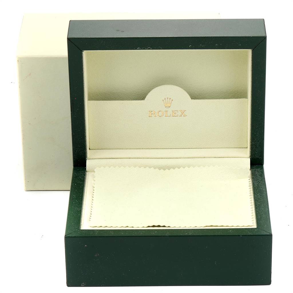 The image shows an open Rolex Datejust 179174 Women
s Stainless Steel Silver Dial 179174 Women
s Stainless Steel Silver Dial watch box with green exterior and a padded interior, with a cloth at the base.