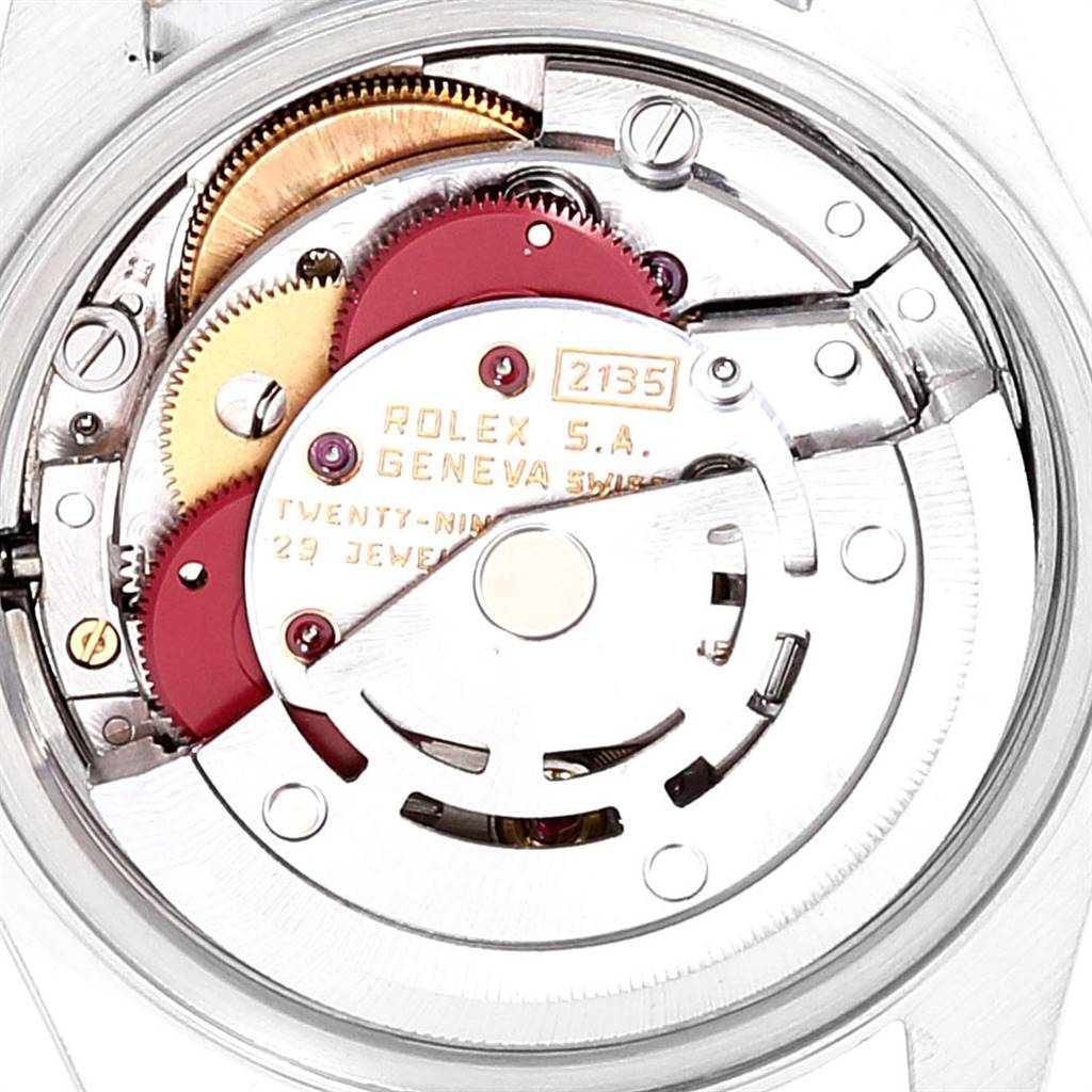 The image shows the internal mechanism of a Rolex Datejust 69173 Women's Stainless Steel Champagne Dial 69173 Women's Stainless Steel Champagne Dial watch, displaying gears, jewels, and the rotor.