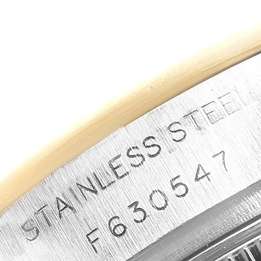 This image shows a close-up view of the casing on a Rolex Datejust 179173 Women's Steel and Gold (two tone) Champagne Dial 179173 Women's Steel and Gold (two tone) Champagne Dial, highlighting the "STAINLESS STEEL" engraving and serial number.