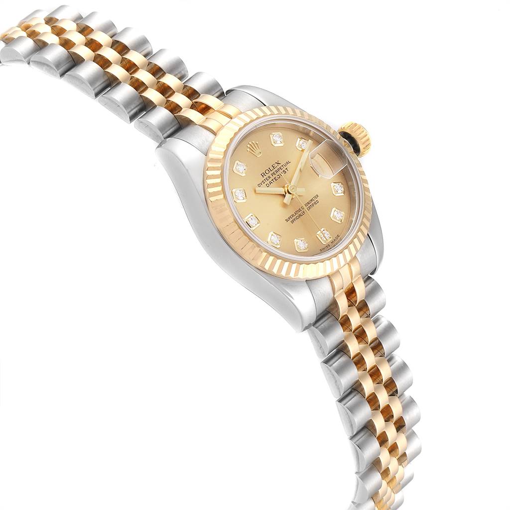 The image shows a Rolex Datejust 179173 Women's Steel and Gold (two tone) Champagne Dial 179173 Women's Steel and Gold (two tone) Champagne Dial watch at a slight side angle, highlighting its gold and silver bracelet, bezel, and diamond hour markers.