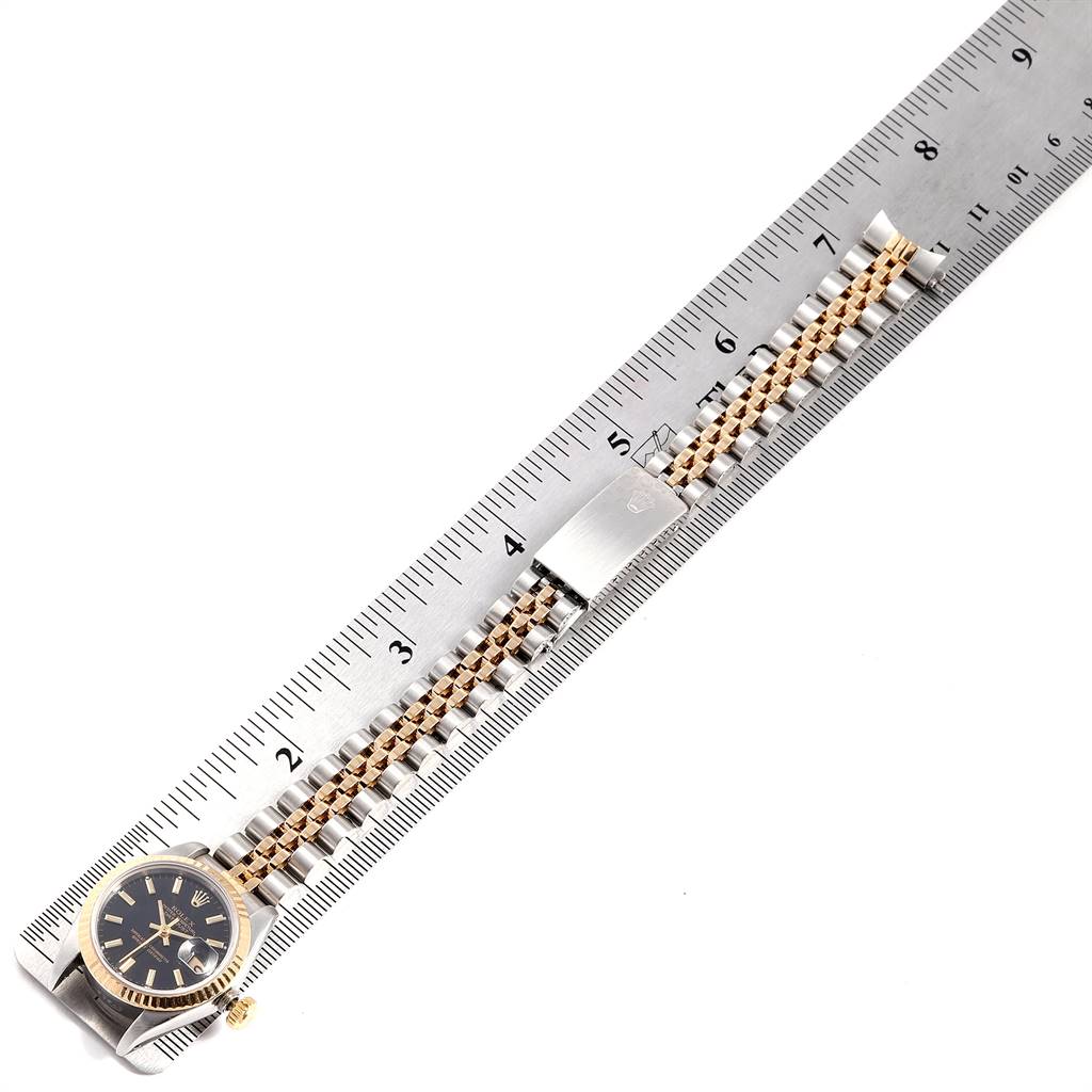 The image shows a Rolex Datejust 69173 Women's Stainless Steel Black Dial 69173 Women's Stainless Steel Black Dial watch and its two-tone bracelet, measured against a ruler.