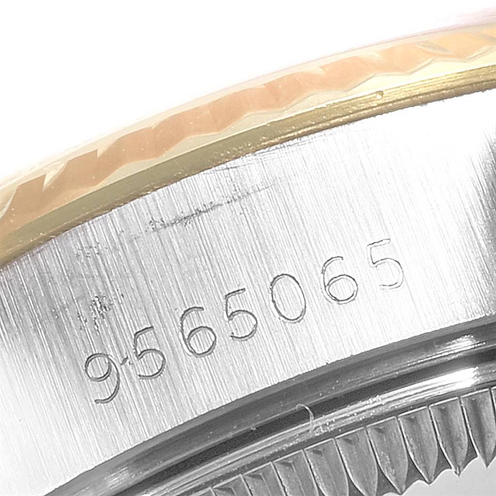 This close-up angle of the Datejust model by Rolex shows the serial number engraved on the watch's case.