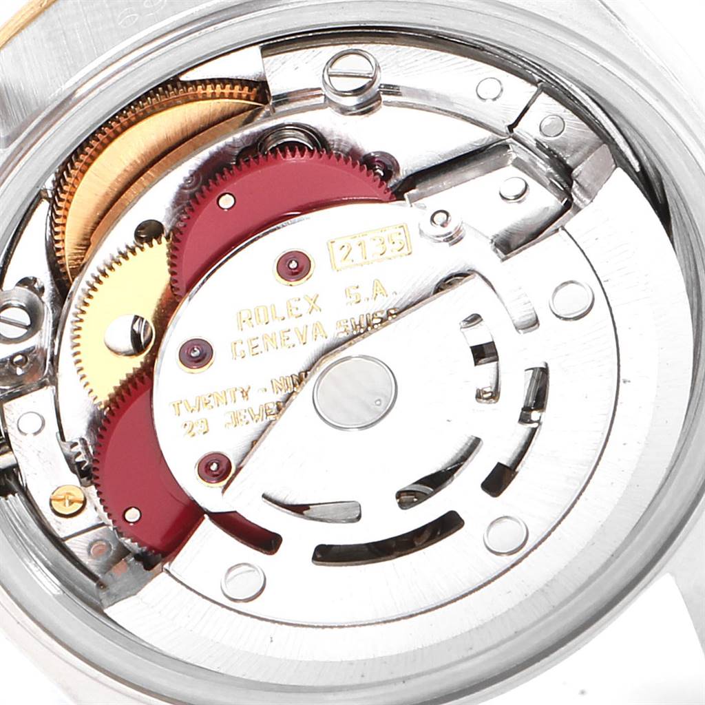 The image shows the internal mechanism of a Rolex Datejust 69173 Women's Stainless Steel Blue Dial 69173 Women's Stainless Steel Blue Dial watch, highlighting its gears and specific components.