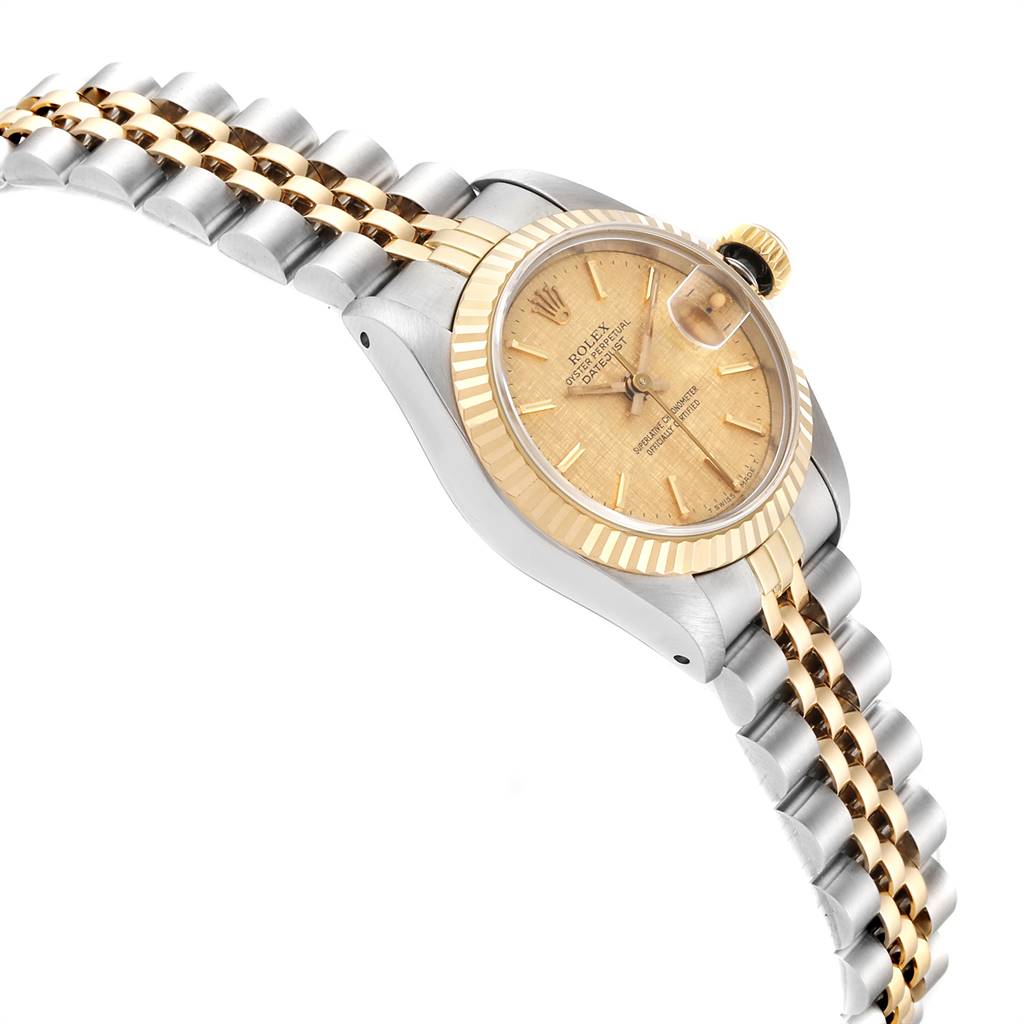 This image shows a side view of the Rolex Datejust 69173 Women's Stainless Steel Champagne Dial 69173 Women's Stainless Steel Champagne Dial watch, highlighting the two-tone bracelet, fluted bezel, and crown.