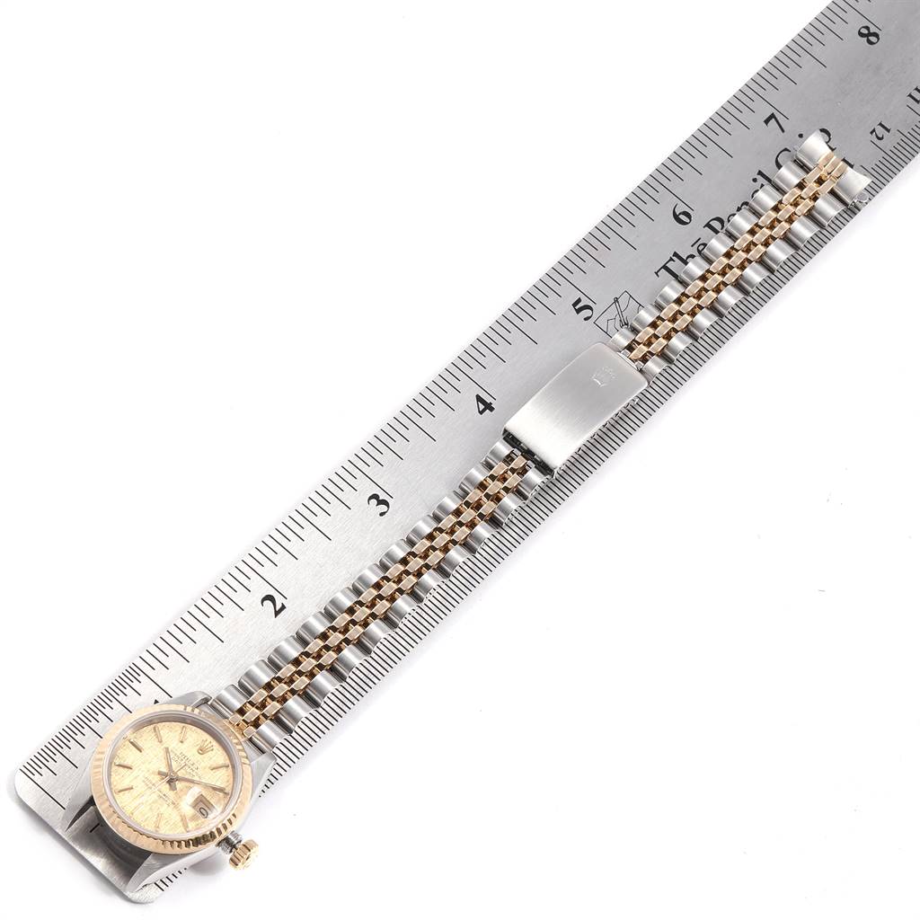 The image shows a Rolex Datejust 69173 Women's Stainless Steel Champagne Dial 69173 Women's Stainless Steel Champagne Dial watch laid flat with its band extended next to a ruler for measurement.